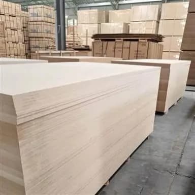 Large inventory of light-colored MDF boards in a warehouse